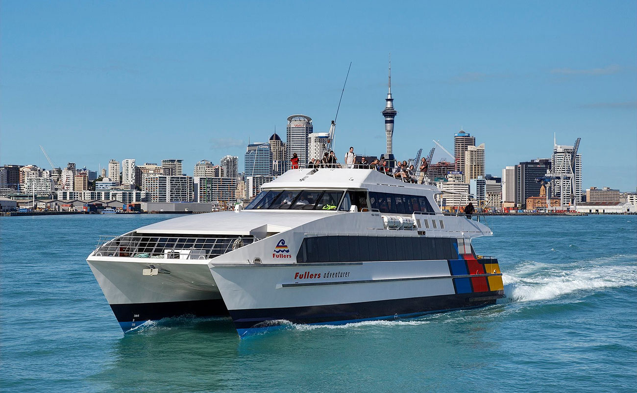 Sailing yacht on Auckland's Waitematā Harbour with the city skyline in the background