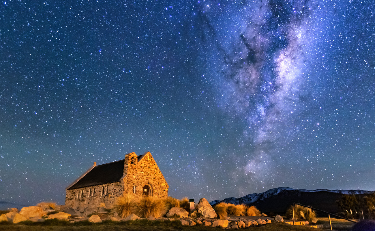 Church of the Good Shepherd beside Lake Tekapo beneath a star-filled sky in the Aoraki Mackenzie International Dark Sky Reserve